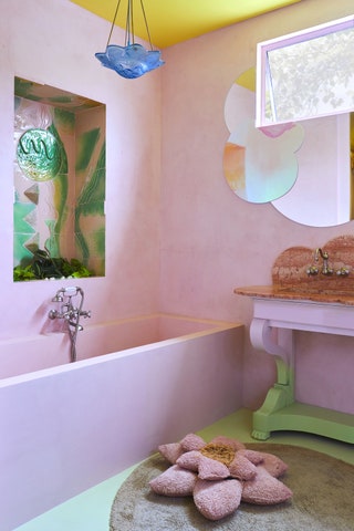 Pale pink bathroom with pink tub cloud shaped mirror pinkandgreen vanity with coral cloudshaped marble top